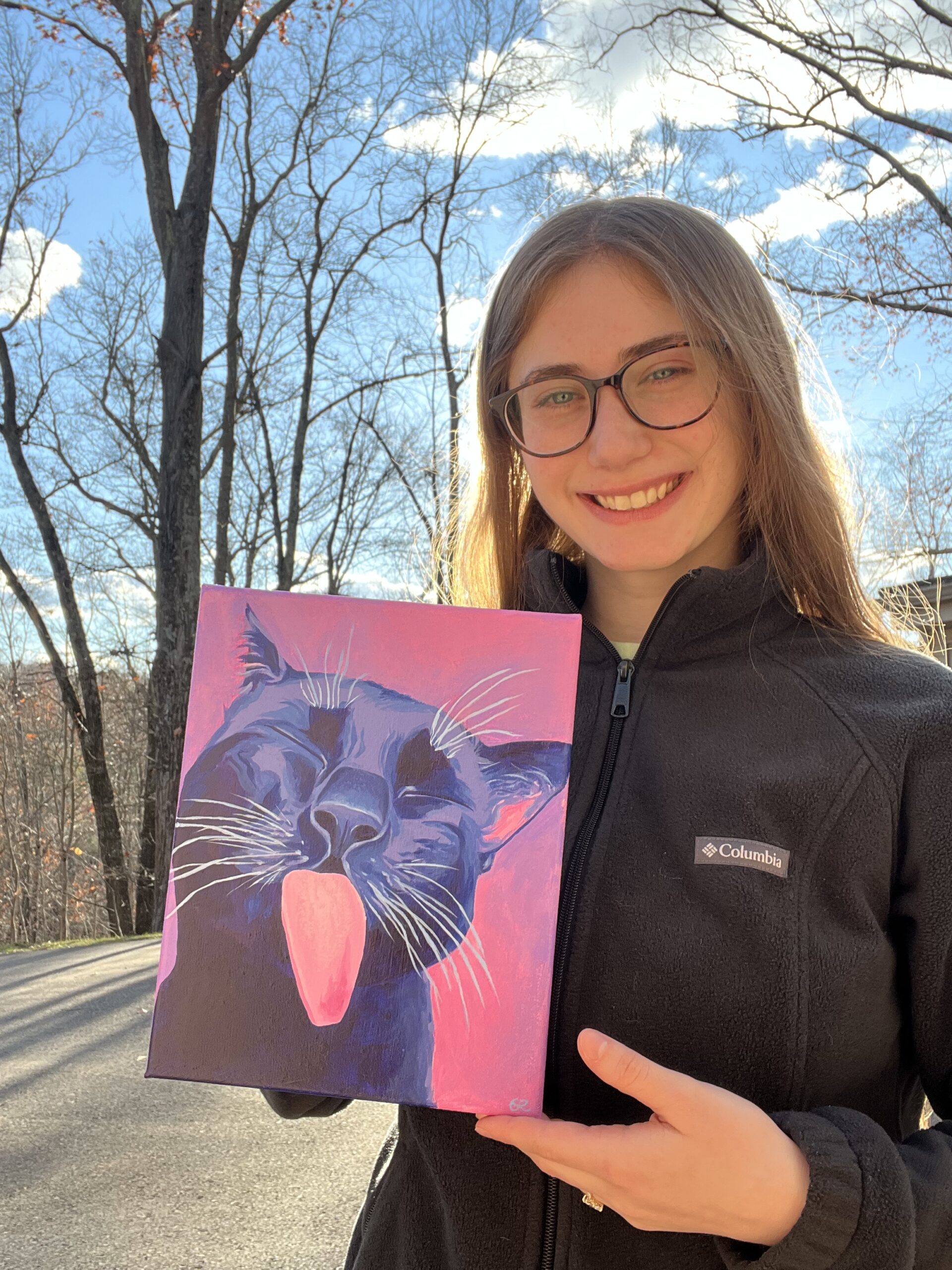 Artist holding a cat acrylic painting on pink and purple background
