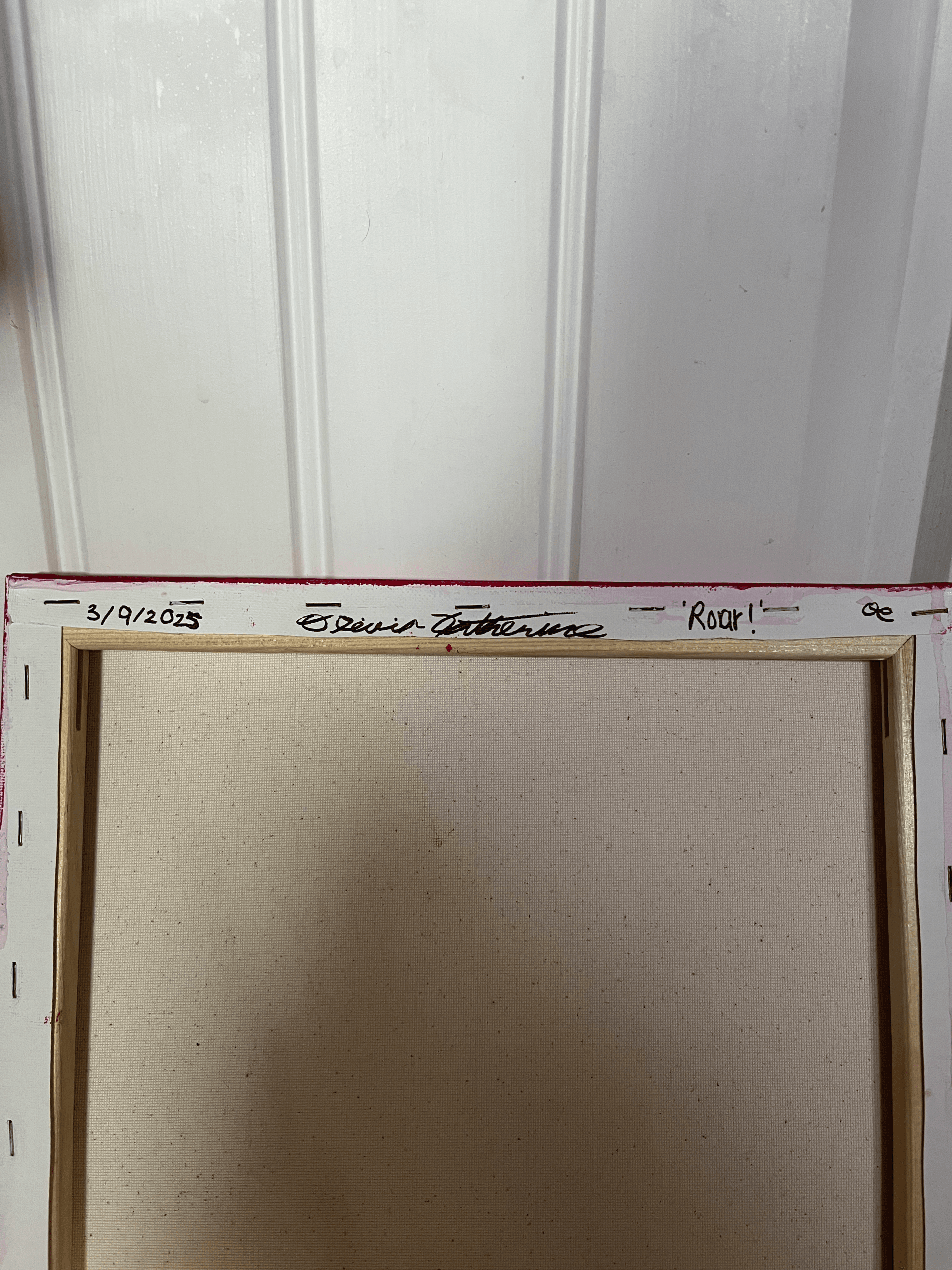 Back of the “Roar!” painting showing the artist’s signature and date.