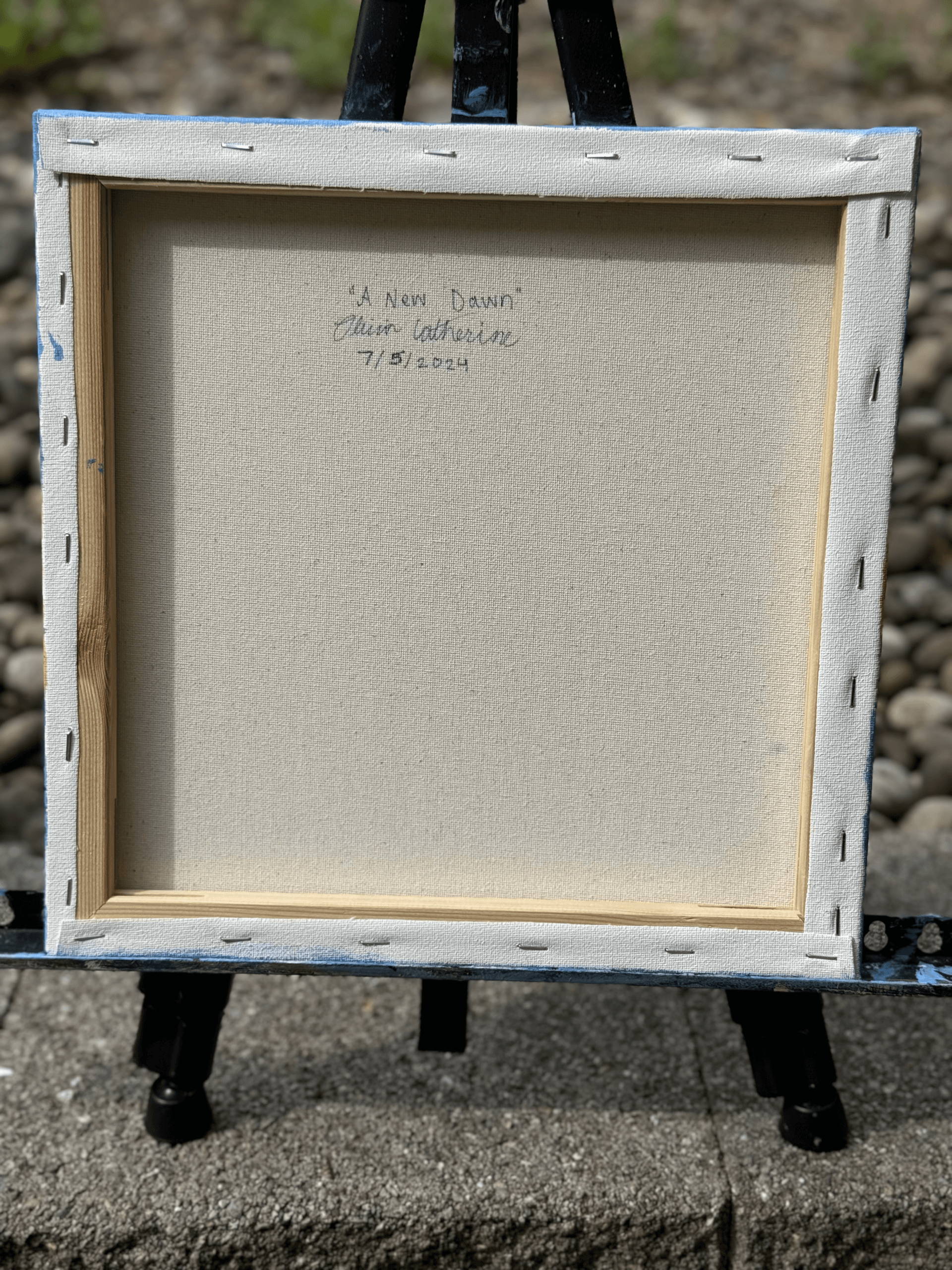 Back of the painting showing the artist’s signature and date