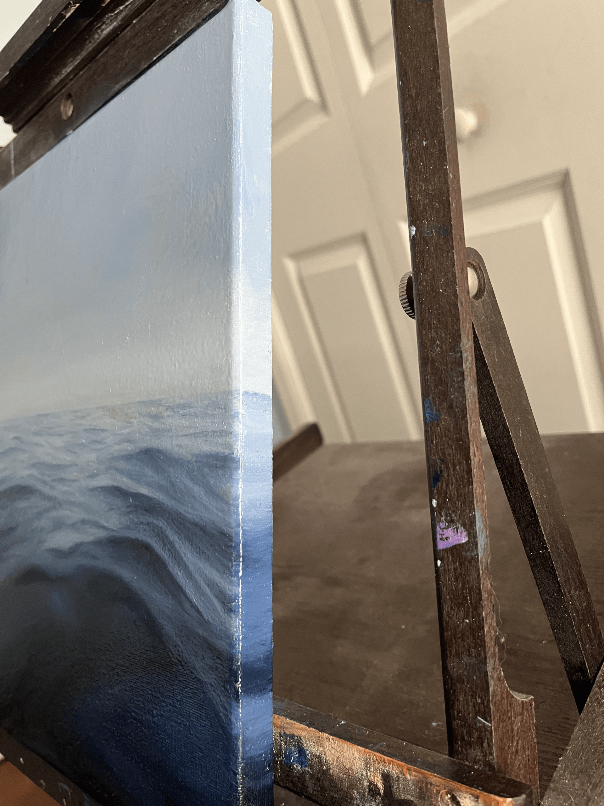 Side view of the “Gentle Sea” oil painting showing the painted wrap-around edges of the canvas.
