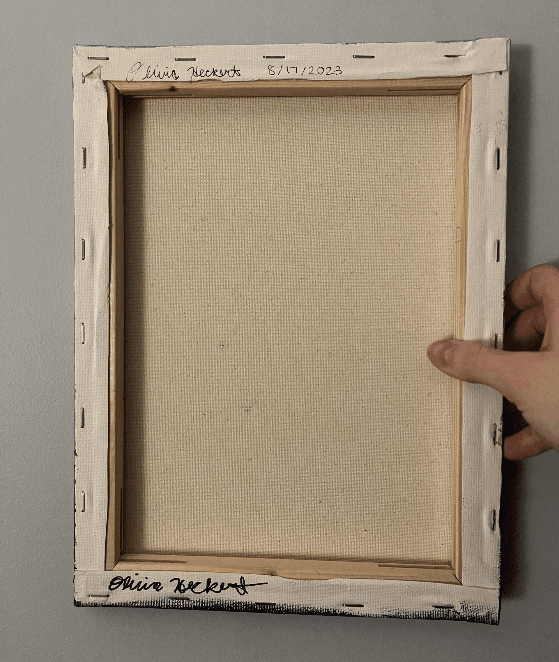 Back of the “Gentle Sea” painting showing the artist’s signature and date