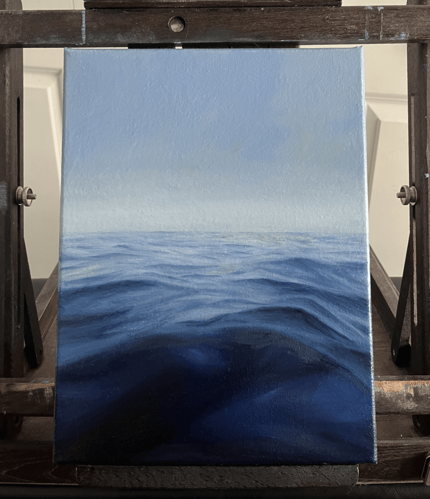Oil ocean painting with soft waves and a pale yellow sky, titled ‘Gentle Sea’ by Olivia Catherine