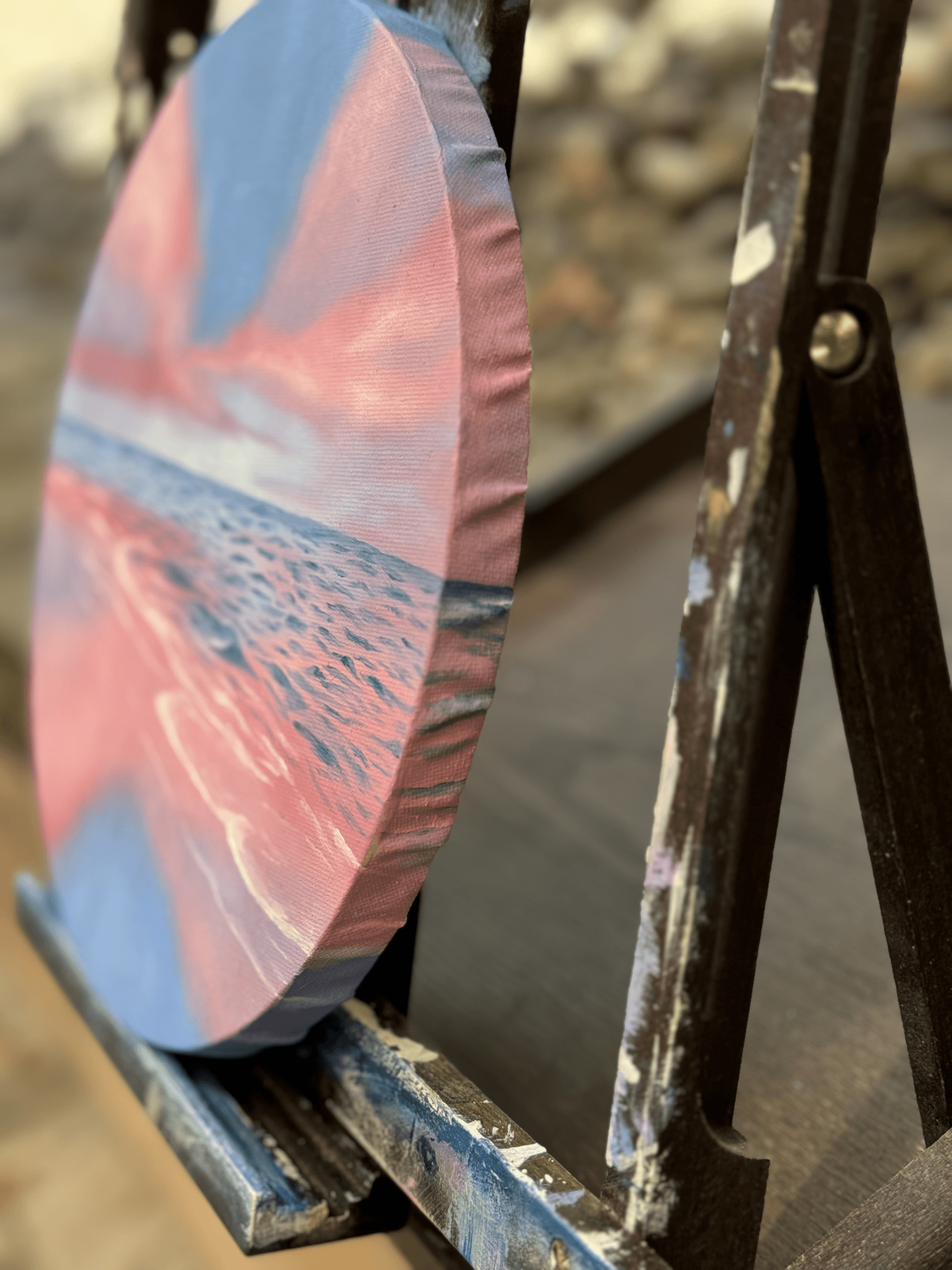 Side view of round canvas showing painted wrap-around edges