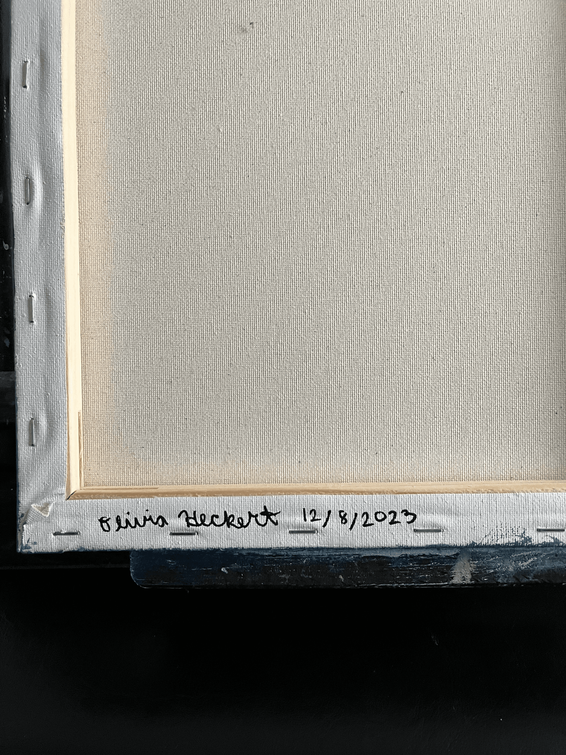 Back of the painting showing artist signature and date